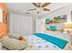 Bedroom featuring comfortable bed, ceiling fan, and dresser, providing a cozy retreat with ample storage solutions at 127 Cypress Pond Rd, Port Orange, FL 32128