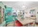 Inviting dining room with a chandelier, coastal-themed decor, and an adjacent kitchen view at 127 Cypress Pond Rd, Port Orange, FL 32128