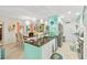 Bright, airy kitchen featuring a breakfast bar with modern pendant lighting and stainless steel appliances at 127 Cypress Pond Rd, Port Orange, FL 32128