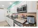 Well-lit kitchen with stainless steel appliances, including a microwave, and dark countertops at 127 Cypress Pond Rd, Port Orange, FL 32128