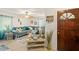 Inviting living room featuring a comfortable blue sofa and a tropical-themed ceiling fan and decor at 127 Cypress Pond Rd, Port Orange, FL 32128