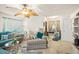 Cozy living room with an accent chair, a leafy ceiling fan and windows with curtains for natural light at 127 Cypress Pond Rd, Port Orange, FL 32128