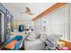 Bright sunroom with ample natural light, cozy seating, and a ceiling fan creating a relaxing additional living space at 127 Cypress Pond Rd, Port Orange, FL 32128