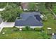 Aerial view of a home with solar panels on the roof and a well-maintained lawn with landscaping at 1310 Pup Fish Ln, Deland, FL 32724