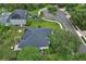Aerial view of a home showing the solar panels, backyard, and neighborhood street at 1310 Pup Fish Ln, Deland, FL 32724