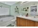 Bathroom featuring a double vanity and a bathtub with decorative tile at 1310 Pup Fish Ln, Deland, FL 32724