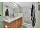 Well-lit bathroom featuring a double vanity and glass-enclosed shower with a stone floor at 1310 Pup Fish Ln, Deland, FL 32724