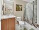 Bathroom with single vanity, toilet, and shower with forest-themed curtain at 1310 Pup Fish Ln, Deland, FL 32724
