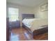 Bedroom with a wooden bed frame, hardwood floors, and a sunny window at 1310 Pup Fish Ln, Deland, FL 32724