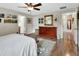 Bedroom with hardwood floors, area rug, and ensuite bathroom at 1310 Pup Fish Ln, Deland, FL 32724
