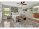 Bedroom featuring a bed, bench, area rug, and windows offering natural light at 1310 Pup Fish Ln, Deland, FL 32724