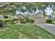 Charming single-story home with well-manicured lawn and mature trees providing ample shade and curb appeal at 1310 Pup Fish Ln, Deland, FL 32724