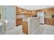 Functional kitchen with wood cabinets, white appliances, and tiled floors, offering a practical cooking space at 1310 Pup Fish Ln, Deland, FL 32724