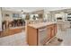 Bright kitchen with white-tiled floors, a breakfast bar, and views into the dining area at 1310 Pup Fish Ln, Deland, FL 32724