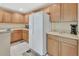 Well-lit kitchen featuring wood cabinets and modern appliances, offering a welcoming atmosphere for cooking at 1310 Pup Fish Ln, Deland, FL 32724
