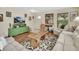 Comfortable living room showcasing hardwood floors, cozy sofas, and a unique wooden coffee table at 1310 Pup Fish Ln, Deland, FL 32724