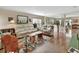 Open-concept living room featuring hardwood floors, comfortable seating, and ample natural light at 1310 Pup Fish Ln, Deland, FL 32724