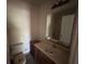 Standard bathroom with toilet, vanity, sink, and medicine cabinet mirror at 1370 19Th St, Orange City, FL 32763