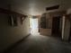 An empty garage with a rear entry door, an electrical panel, and exposed utilities at 1370 19Th St, Orange City, FL 32763