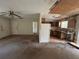 A view from the living room into a kitchen with cabinets and a refrigerator at 1370 19Th St, Orange City, FL 32763