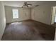 An empty living room with a ceiling fan and views of a hallway and a doorway to another room at 1370 19Th St, Orange City, FL 32763