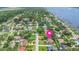 An aerial view featuring a single-story home with mature landscaping, located in a waterfront neighborhood at 1411 N Beach St, Ormond Beach, FL 32174