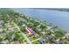 Beautiful aerial view of a single-story home in a waterfront neighborhood with mature landscaping and waterfront views at 1411 N Beach St, Ormond Beach, FL 32174