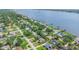 A beautiful coastal aerial view of a waterfront community with docks, homes, and mature trees on a sunny day at 1411 N Beach St, Ormond Beach, FL 32174