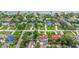 Aerial view of a residential neighborhood with mature trees, swimming pools, and well-manicured lawns on a sunny day at 1411 N Beach St, Ormond Beach, FL 32174