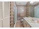 Well-lit bathroom featuring a vanity, toilet, walk-in shower, and built-in storage at 1411 N Beach St, Ormond Beach, FL 32174