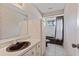 Neutral bathroom featuring a single sink vanity, cabinet, tile floors, and shower with curtain at 1411 N Beach St, Ormond Beach, FL 32174