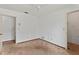 White bedroom featuring two doorways, with neutral walls, a ceiling fan, and wall outlets at 1411 N Beach St, Ormond Beach, FL 32174