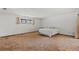 Spacious bedroom featuring a window and a neutral color scheme, with carpet floors and a queen size bed at 1411 N Beach St, Ormond Beach, FL 32174