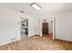 Carpeted bedroom showcasing a kitchen and china cabinet through open doorways at 1411 N Beach St, Ormond Beach, FL 32174
