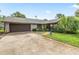 Charming single-story home with a two-car garage, mature landscaping and a well maintained lawn at 1411 N Beach St, Ormond Beach, FL 32174