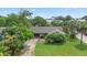 A charming single-story home with a lush front yard and mature trees, offering a serene and private setting at 1411 N Beach St, Ormond Beach, FL 32174