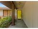 Welcoming entrance featuring a bright yellow front door, stone accents, and lush greenery at 1411 N Beach St, Ormond Beach, FL 32174