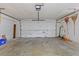 Spacious garage with a roll-up door, ample storage space, and a concrete floor, ready for your vehicles and projects at 1411 N Beach St, Ormond Beach, FL 32174