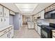 Well-lit kitchen with classic white cabinets, modern appliances, and tile flooring at 1411 N Beach St, Ormond Beach, FL 32174
