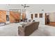 Bright living room featuring a wood paneled accent wall, plush carpeting, and expansive windows for natural light at 1411 N Beach St, Ormond Beach, FL 32174
