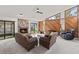 Bright living room with a stone fireplace, wood paneled accent wall and sliding doors to the screened patio at 1411 N Beach St, Ormond Beach, FL 32174