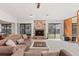 Spacious living room with a stone fireplace, plush carpeting, and access to the backyard at 1411 N Beach St, Ormond Beach, FL 32174