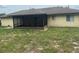 The home's backyard has a screened in porch that spans the length of the back side of the home at 1556 Ferendina Dr, Deltona, FL 32725