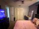 Bedroom with a pink bed and a makeup table, perfect for relaxing after a long day at 1556 Ferendina Dr, Deltona, FL 32725