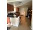 Kitchen with wood cabinets, black countertops, tile flooring, and stainless steel appliances at 1556 Ferendina Dr, Deltona, FL 32725
