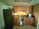 Efficient kitchen with stainless steel appliances and ample cabinet space, perfect for culinary enthusiasts at 1556 Ferendina Dr, Deltona, FL 32725