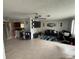 Inviting living room featuring tile flooring, ceiling fan, and view to the open-concept kitchen at 1556 Ferendina Dr, Deltona, FL 32725