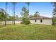 Large backyard with green grass, privacy fence, and the exterior of the home, creating a peaceful outdoor space at 1683 10Th Ave, Deland, FL 32724