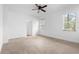 Bright, spacious bedroom with neutral carpeting, white walls, a ceiling fan, and ample natural light at 1683 10Th Ave, Deland, FL 32724