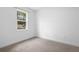 Bedroom featuring a carpeted floor and a window overlooking the backyard at 1683 10Th Ave, Deland, FL 32724